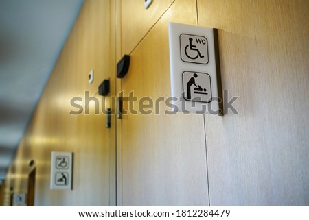 signs indicating the toilet for the disabled in a public place