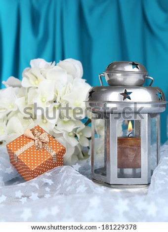 Decorative metallic lantern on fabric background