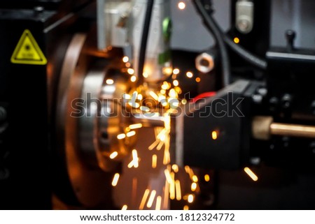 Blur image for use as a background. As picture of metal tube laser cutting And sparks from cutting steel pipes