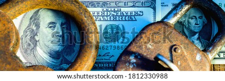 Concept: security is worth the money, protecting your valuables. Security locks lie on money. Horizontal image.