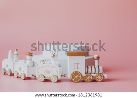 For Christmas or New Year holiday greeting card. Toy's train on pink background.