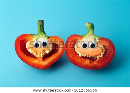 Funny vegetables for kids. Cheerful Peppers with eyes and smiles. Food for kids concept.