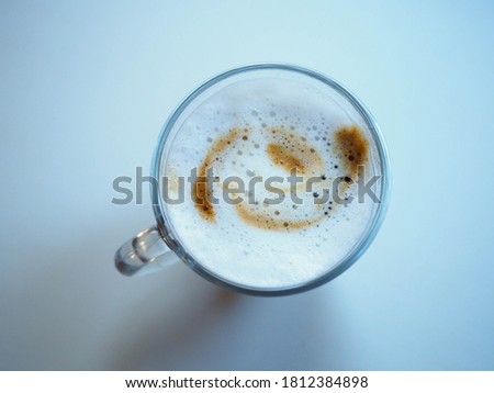 picture of a cup of coffe with milk taken from above 