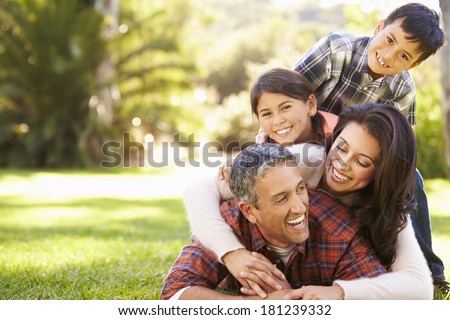 Family Lying On Grass In Countryside Royalty-Free Stock Photo #181239332