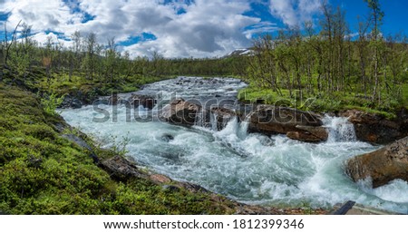 Large turquoise River landscape  and mountainous valley in Padjelanta national park in northern Sweden with large wild river.
