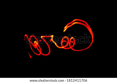 Creative conceptual fine art photography motion blur sparkle light trail on dark. Artistic design by lamp fire flame line at night slow shutter speed of camera exposure.