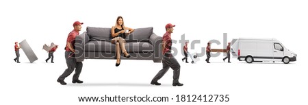 Movers carrying a couch with a young woman sitting and drinking coffee while other movers loading a van isolated on white background