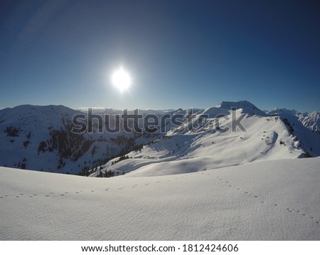 Spectatular view from the top of the austrian Alps. Clear blue sky and shining sun.