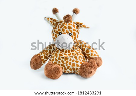 Giraffe plush doll isolated on white background with shadow reflection. Giraffe plush doll on white background. Colorful plush toy. Colored stuffed toy-giraffe. White brown giraffe