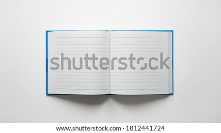 Open note book with blue cover , isolated on neutral white background.