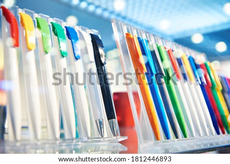 Modern colored plastic ballpoint pens on store display Royalty-Free Stock Photo #1812446893