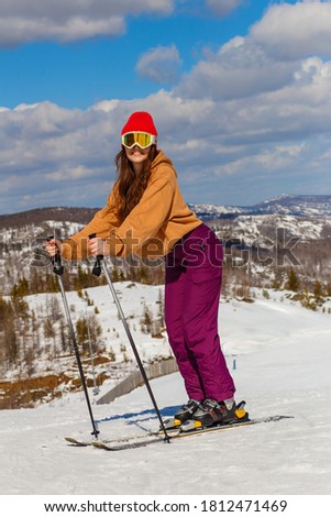  Teenage girl skis in the mountains
