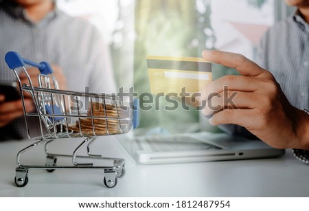 businesswoman hand using smart phone,mobile p payments online shopping,omni channel,digital tablet docking keyboard computer at office in sun light