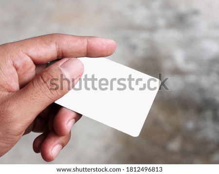 Male hand with white empty card  close-up photo 