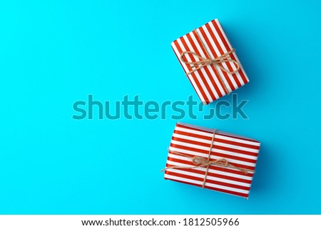 Red and white striped gift box on blue background