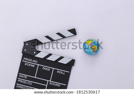 Movie clapper board and globe on white background. Filmmaking, Movie production, Entertainment industry. Top view