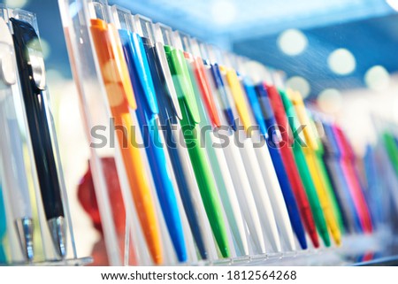 Modern colored plastic ballpoint pens on store display Royalty-Free Stock Photo #1812564268
