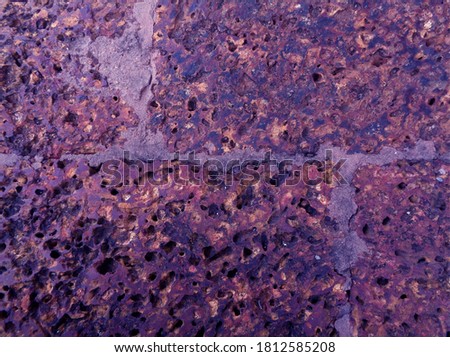 Purple colored rough old stone floor surface