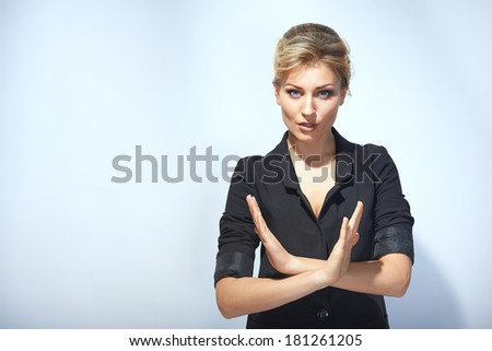 Serious businesswoman making stop sign