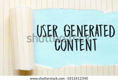 The text USER GENERATED CONTENT appearing behind torn white paper