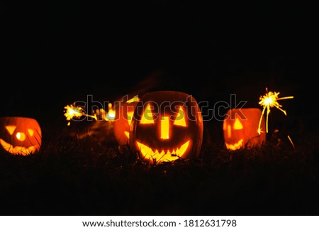 Halloween pumpkins over blue  background with smoke and sparkles. 