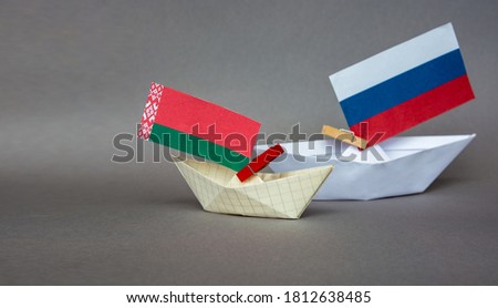 paper boat with the flag of belarus  and russia,  europe. Royalty-Free Stock Photo #1812638485