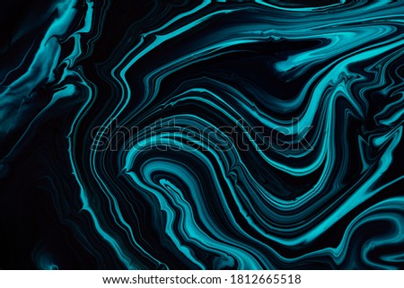Fluid art texture. Abstract backdrop with swirling paint effect. Liquid acrylic artwork that flows and splashes. Mixed paints for posters or wallpapers. Blue, black and aquamarine overflowing colors.