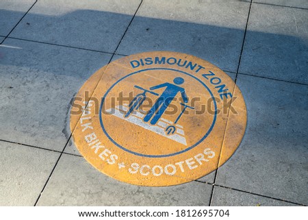 Dismount zone sign for bicycles and scooters