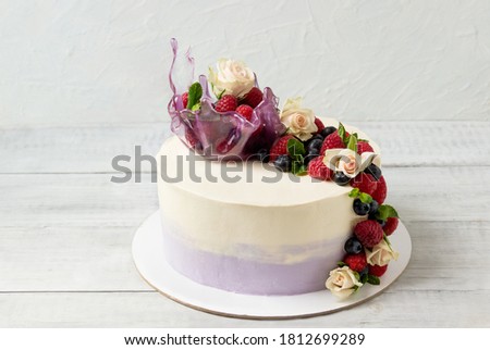 Cake with roses, fresh berries and isomalt vase. Birthday cake.