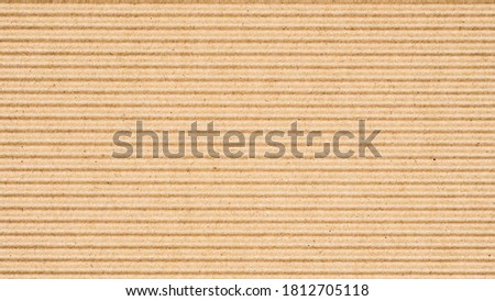 Abstract brown recycled paper vertical lined texture background. 
Old Kraft box craft paper stripes pattern seamless. 
top view.