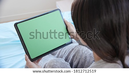 telemedicine concept - asian female patient use green screen tablet to see the doctor