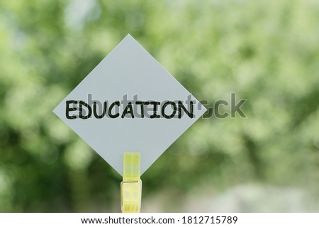 EDUCATION text on a piece of paper on notes on a green background. Copy space for your design