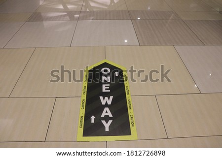 floor with one-way warning sticker. health protocol in the modern market during the new normal