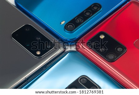 Four smartphones with different cameras close-up.