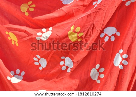 red background with paw prints. colored paw prints. abstract red background