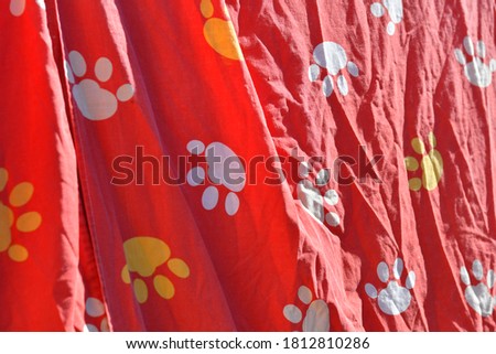 red background with paw prints. colored paw prints. abstract red background