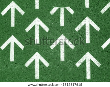 White arrows on asphalt road. conceptual background              