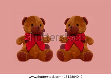 Image of cute teddy bears sitting brown color on pastel pink background