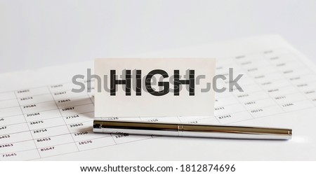 Text HIGH on stickers,pen on the background of documents. Financial bookkeeping, Accounting Concept.