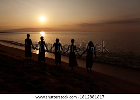 
Women holding hands at sunrise Royalty-Free Stock Photo #1812881617
