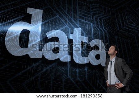 The word data and serious businessman with hands on hips against futuristic black and blue background