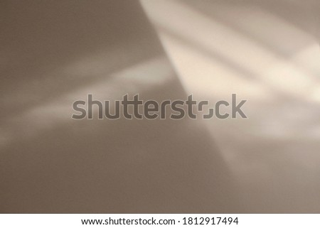 Diagonal natural shadow overlay effect on a textured surface toned in sand color.Window shadow concept for background, product presentation, mockup, photo, posters and wallpapers.