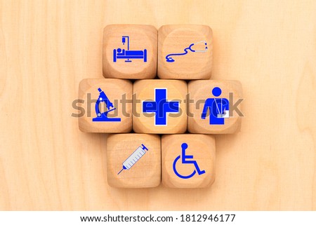 Medical care as a symbol on wooden cubes