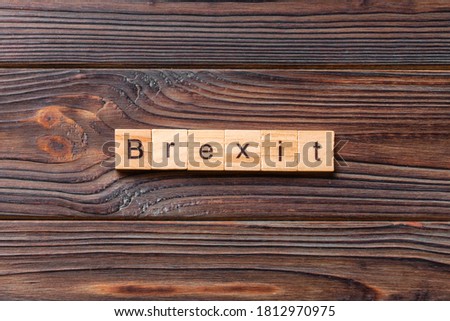 Brexit word written on wood block. Brexit text on cement table for your desing, concept.