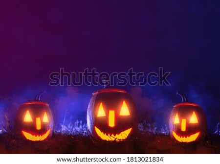 Halloween pumpkins over blue  background with smoke. Happy  Halloween day party banner.