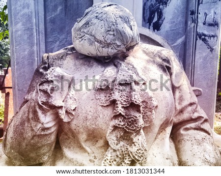 Ancient architectural tombstone of praying woman without head. background for horror