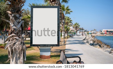 vertical advertise empty display with white mockup place on sea promenade front view