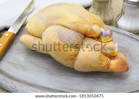 whole raw guinea fowl on a cutting board Royalty-Free Stock Photo #1813050475