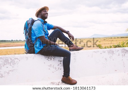 African tourist  traveler man with backpack on view of mountain background