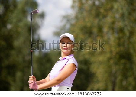 Golfer hits with a club during the tournament